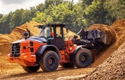 New Loader lifting dirt in field,New Hitachi Loader on construction site,Hitachi Loader moving dirt,Hitachi loader scoping up dirt,Hitachi loader scoping up dirt